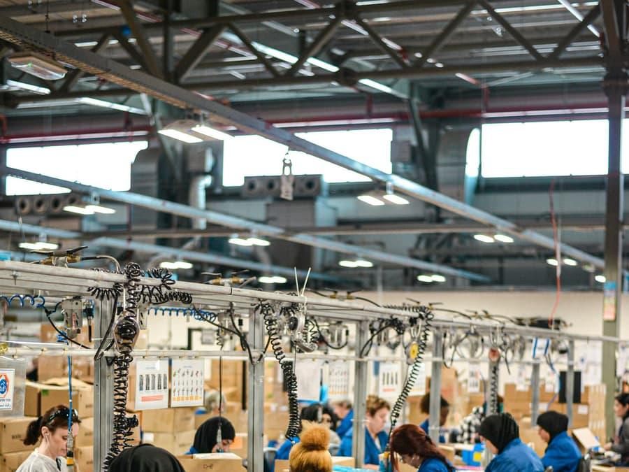 Assembly line workers packing products on a factory floor