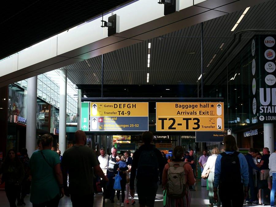 Travellers moving through an airport arrivals hall